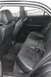 2002 Lexus IS 300 - The rear interior of a 2002 Lexus IS 300 features black leather and suede seats with visible seat belts.