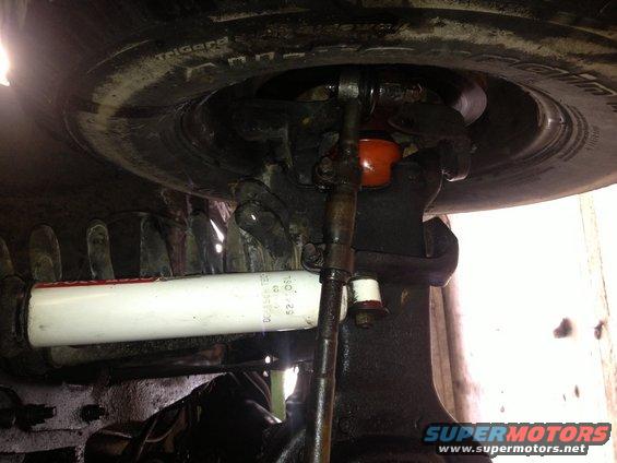 close-up of vehicle's steering linkage and shock absorber