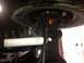 1995 Ford Bronco - Underside view of a vehicle's suspension system, showing the steering linkage and a white shock absorber.