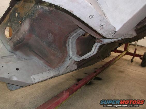 Undercarriage of a 1967 Ford Mustang showing the frame and suspension components