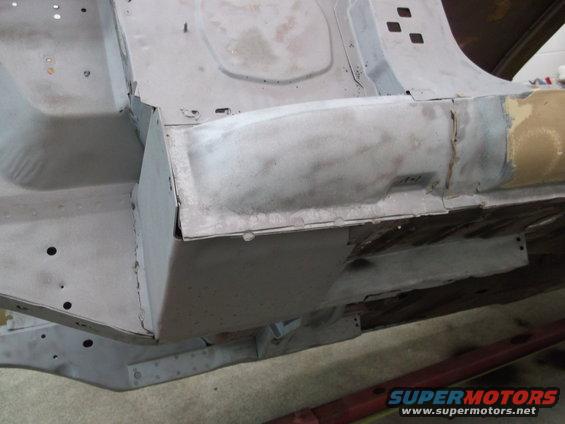 Close-up of car's undercarriage showing metal repair work on the frame