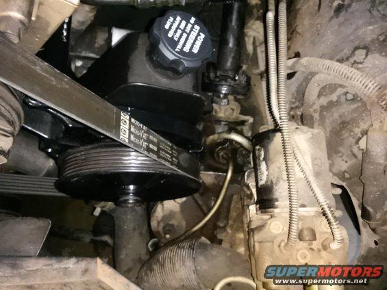 Engine power steering reservoir and belt pulley system