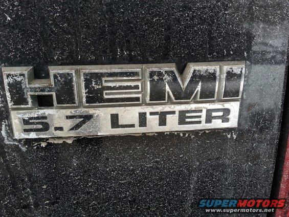 HEMI 5.7 LITER badge on a dusty black surface