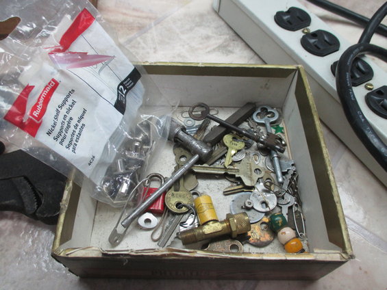 Box of assorted keys, padlocks, and hardware, including Rubbermaid shelf supports