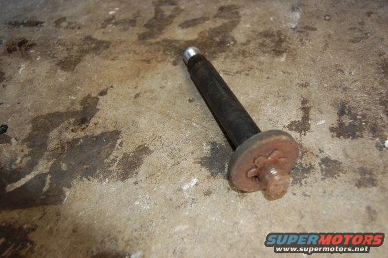 Bolt with a rusty star-shaped washer on a concrete surface
