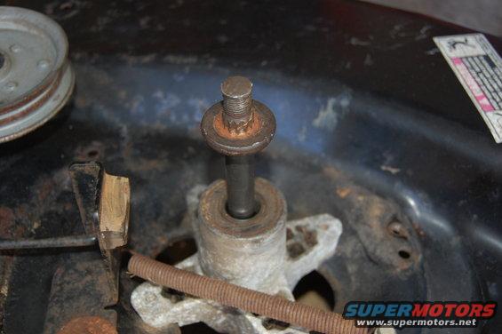 Lawn mower deck spindle assembly with rusty bolt and pulley