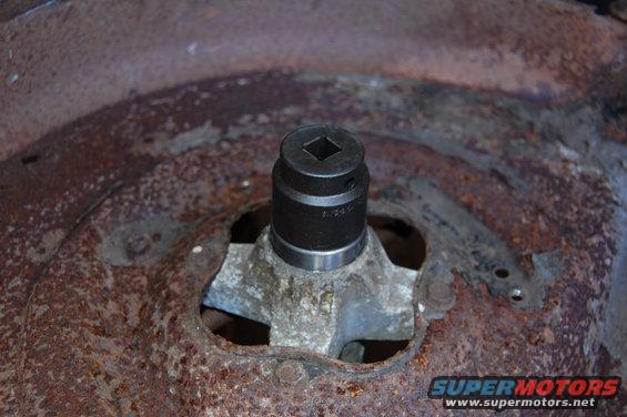 Socket on a rusty metal part with visible text '1.24.1'