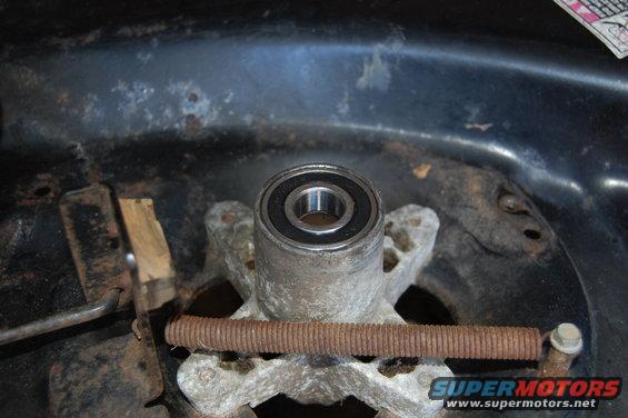 Lawn mower deck spindle bearing with rusty spring