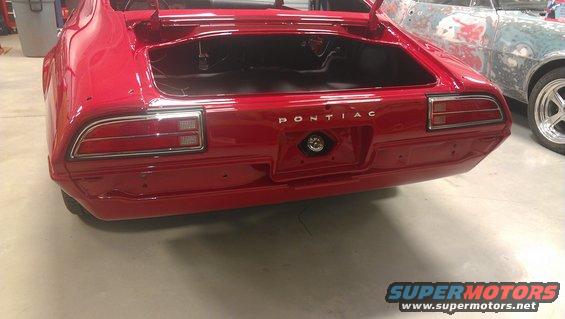 Red 1970 Pontiac Firebird rear view with trunk open, another car in background