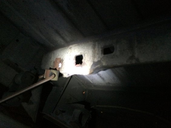 Undercarriage with a broken fuel tank strap mount