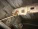 1964 Ford Ranchero - The fuel tank strap appears to have broken, revealing the undercarriage of the vehicle.