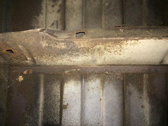 Undercarriage frame with rust and a hole