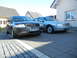 1999 Ford Fairlane - Two cars, an Audi and a light blue sedan, are parked on a paved driveway in front of a house.