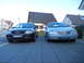 1999 Ford Fairlane - Two sedans, an Audi and a silver sedan, are parked side-by-side in a driveway.
