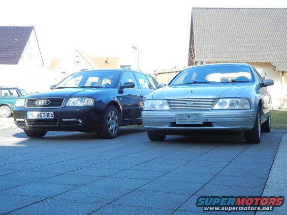 Silver Ford sedan and blue Audi wagon parked on a tiled driveway