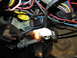 1979 Ford F-150 - A close-up view of a vehicle's complex wiring harness, showing a lit bulb and various connectors.