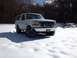 1992 Ford Bronco - A white 1992 Ford Bronco sits in a snowy landscape under a bright sky.