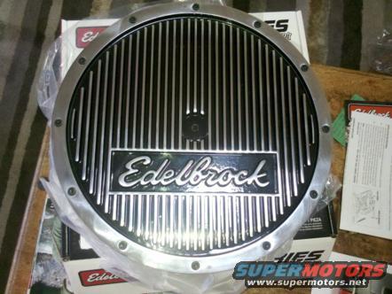 Edelbrock finned aluminum oil pan with black inserts and a central bolt