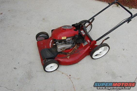 Red Craftsman lawn mower with engine visible