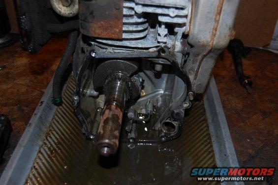 Engine crankshaft and casing in a drain pan with oil
