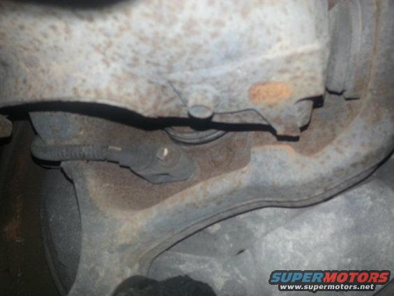 ABS sensor wire attached to rusty suspension arm