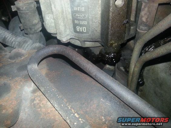 Close-up of a Ford ABS sensor with leaking fluid and hoses