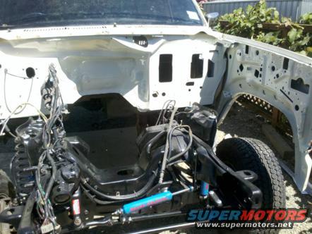 1982 Ford Bronco engine bay with blue shock absorber and wiring