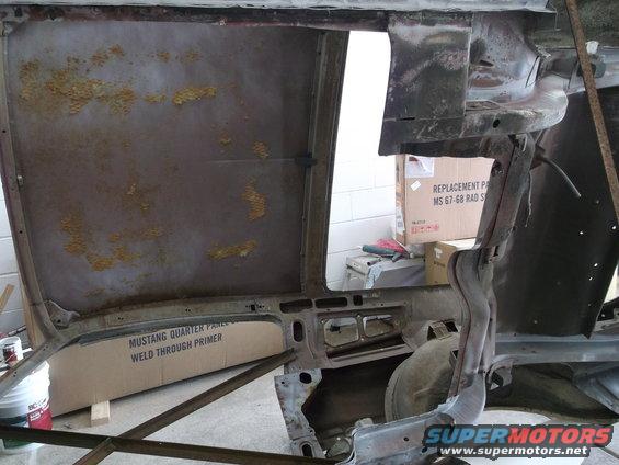 Car body interior with boxes of parts, one labeled 'Mustang Quarter Panel Weld Through Primer'