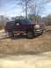 1996 Ford Bronco - Maroon 1996 Ford Bronco with a tan removable top is parked outdoors.