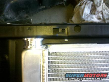radiator cap and fins, part of engine bay structure, and a rag
