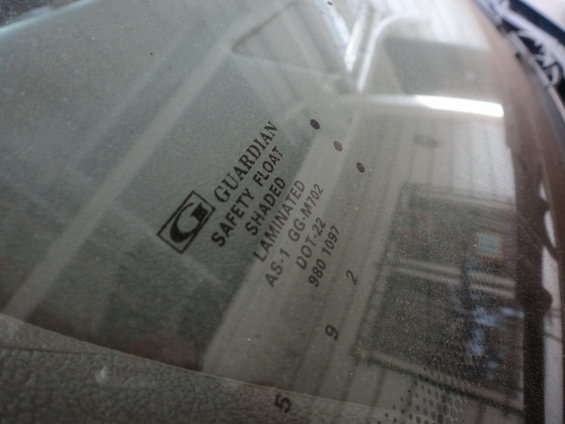 Windshield glass showing Guardian Safety Float Laminated markings and DOT-22 code