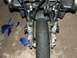 2006 Honda Reflex - The front end of a motorcycle shows damage, with broken blue fairing pieces on the ground.