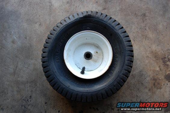 Tire and wheel assembly with 'TUBE SAVER' text visible on the tire sidewall