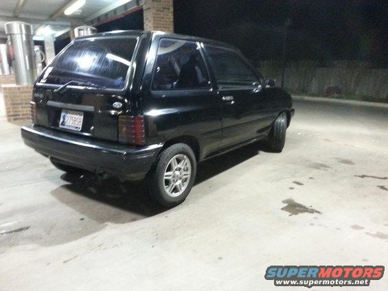 black 1991 Ford Festiva parked at night
