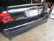 2007 Ford Crown Victoria - The rear of a black car is shown, a spoiler, an 'Interceptor' badge, and a California license plate.