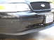 2007 Ford Crown Victoria - The front grille and headlights of a black Ford Crown Victoria are visible, along with a California license plate.