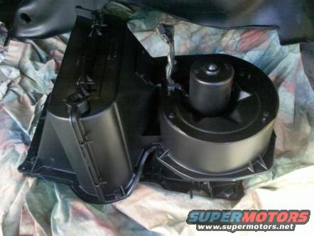 HVAC blower motor assembly with fan and housing, painted black