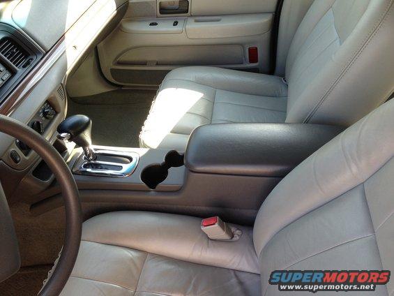 Car interior with light gray leather seats, center console, and gear shifter