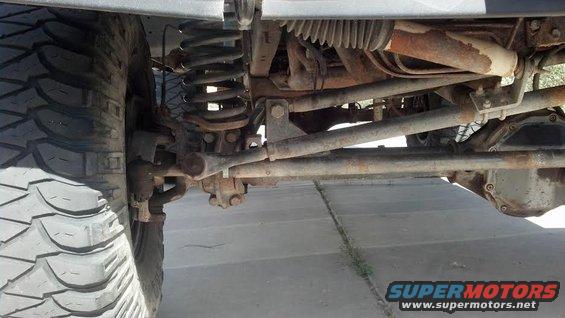 Undercarriage of a vehicle with large tire, suspension components, and differential