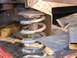 1978 Ford Bronco - Detail of a vehicle's suspension system, showing a coil spring and rusted metal parts.