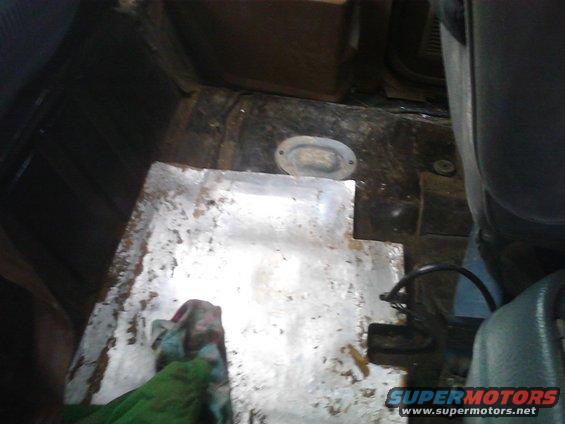 Interior floor of a vehicle with a metal plate covering part of it