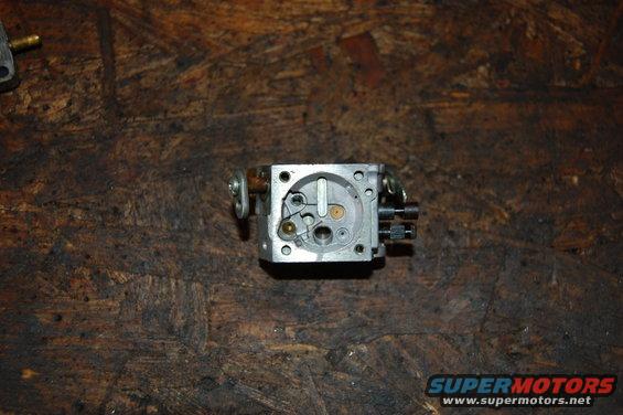 Carburetor part on a wooden surface