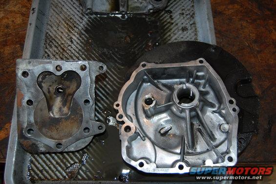 Engine crankcase and cylinder head disassembled in a tray