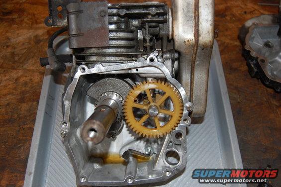Engine block with exposed crankshaft and yellow plastic gear