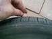 1993 Ford Probe - Penny test shows tire tread depth is low, indicating wear.