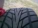 1993 Ford Probe - A close-up view of a tire's tread pattern is shown, with a red cloth visible on the left side.