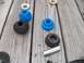 1998 Lincoln Mark VIII - Suspension bushings and hardware laid out on a wooden surface.