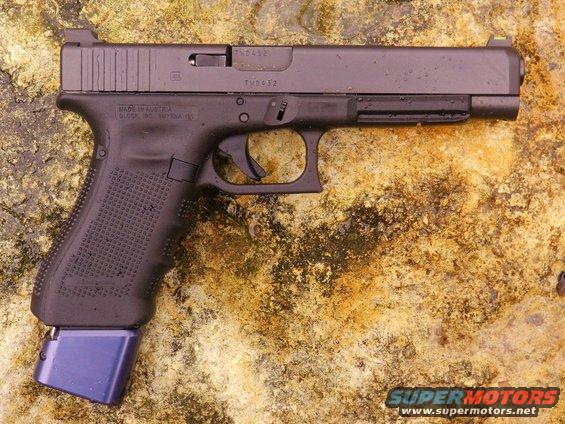 Black Glock pistol with extended blue magazine base plate, side view
