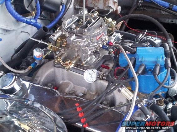 Engine bay with chrome air cleaner, Holley carburetor, and blue MSD distributor