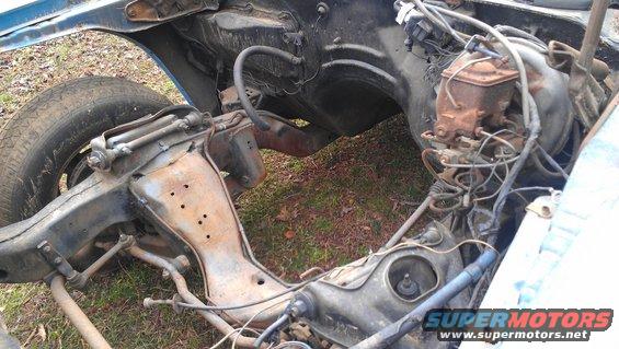 Car frame with suspension components, brake master cylinder, and wiring visible